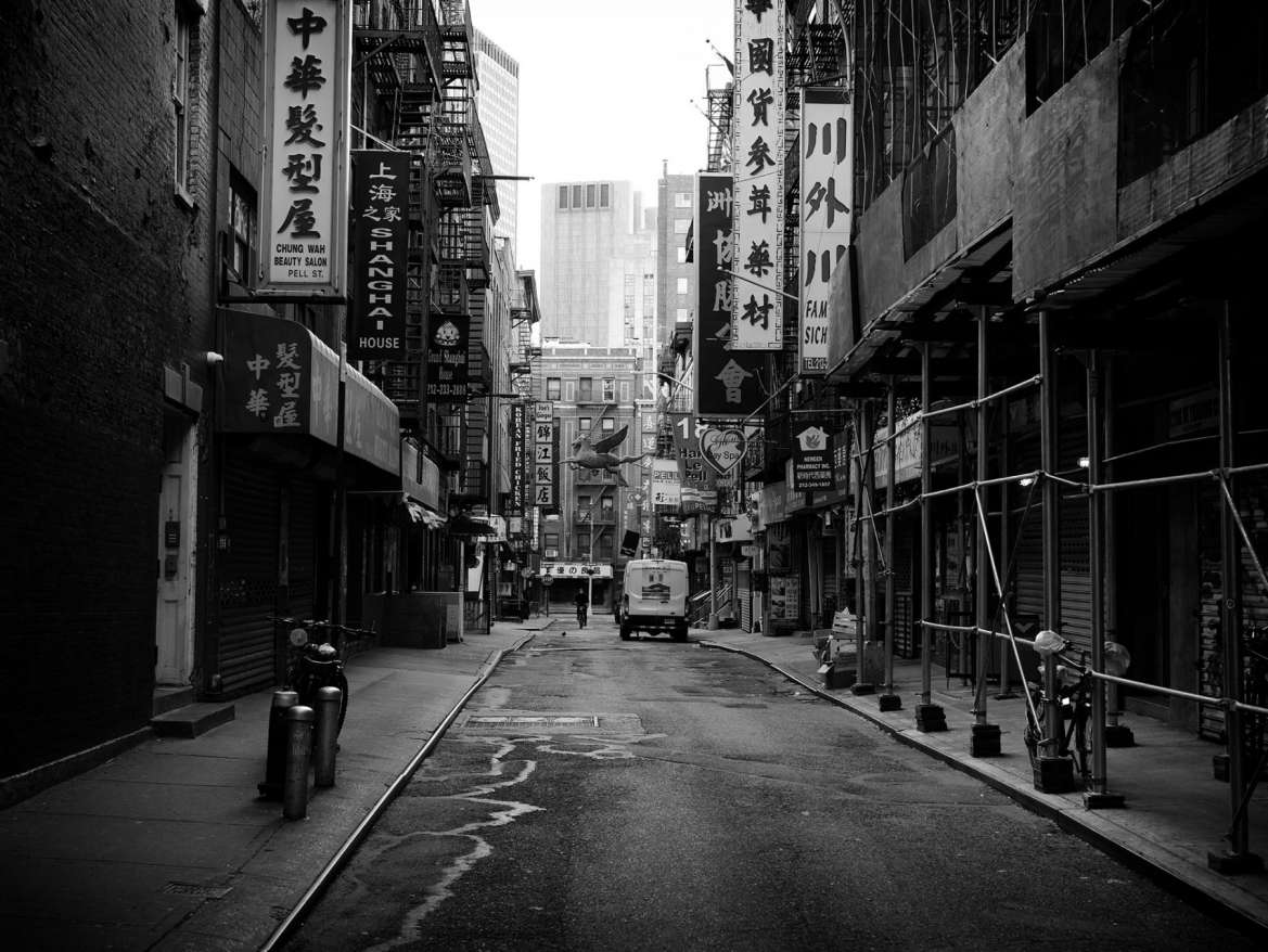 Black and white photograph of a deserted street in Chinatown.