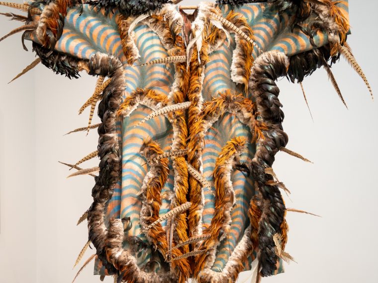 Carlos Villa, Third Coat, 1977. Feathers and acrylic on canvas; Inside lining: Bone dolls and
acrylic on taffeta, 82 x 80 in. Collection of di Rosa Center for Contemporary Art.