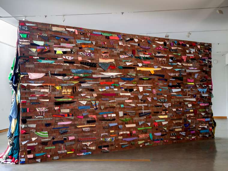 Karyn Olivier, Wall, 2017–2018. Bricks, used clothing, steel. Courtesy of the artist.