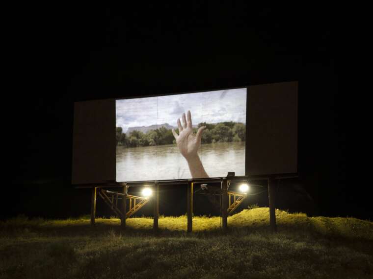 Projection of “Localized Gestures” film on a vacant billboard in Green River, Utah, by artist Calista Lyon. Photo by Calista Lyon. 