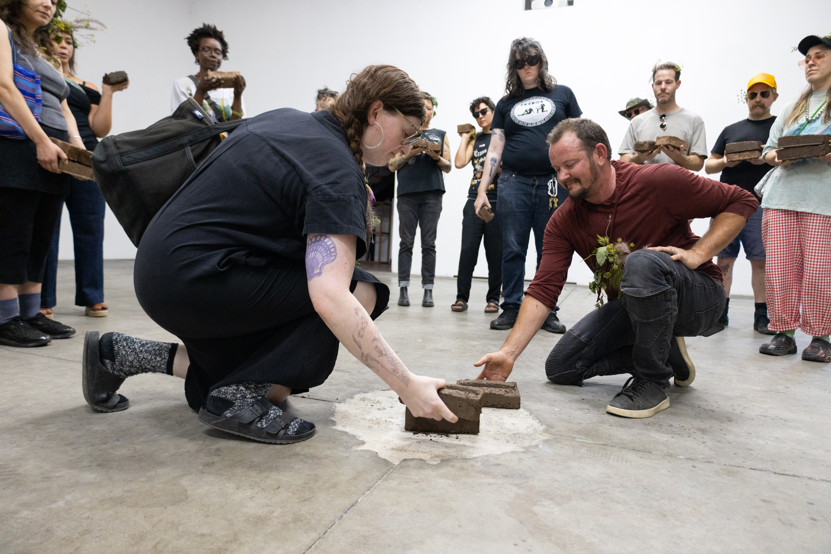 Nicki Green and Ashton S. Phillips placing Divine Portent joule bricks inside HRLA, at close of public Procession. September 14, 2024. Photo by Argel Rojo