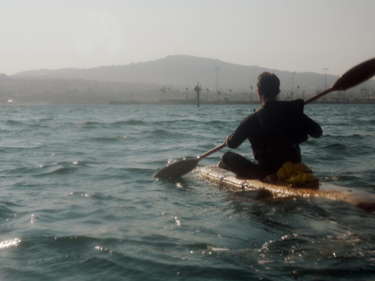 Sam Shoemaker in his mushroom boat after crossing the Catalina Channel on August 5, 2025. Photo by Jordan Freeman. Courtesy Fulcrum Arts.
