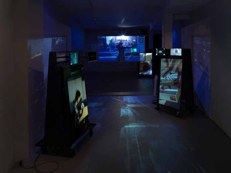 Allison Nguyen, Perforation, Ellipse V01, 2026. Multi-channel video, color, sound,
glass screen, steel, casters, gold on aluminum, colored gels, 11′ 16″ loop. Courtesy
the artist and Storefront for Art and Architecture. Photo: Dario Lasagni