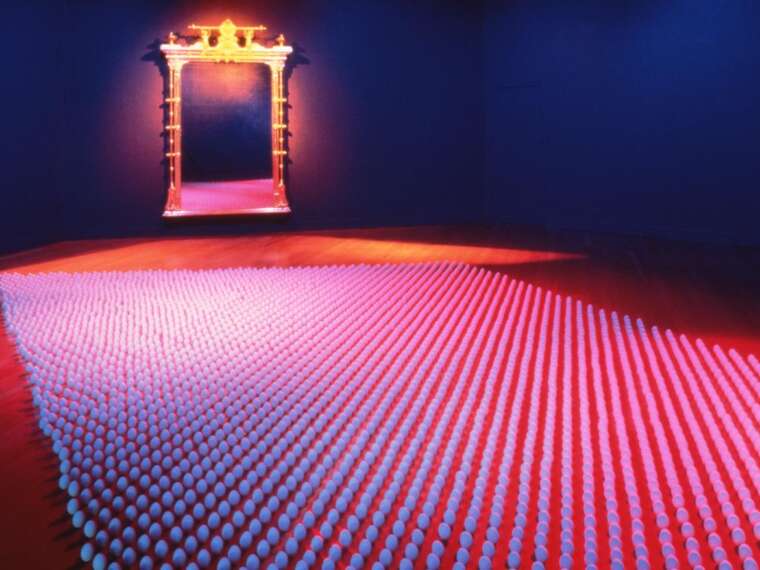 Mildred Howard, Crossings, 1997. Antique gilded frame, ceramic eggs, filtered ambient light. Installation view. Photo by Lewis Watts.