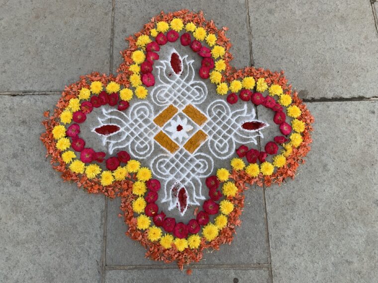 Kelly Han, Auroville Beach from Bless This House series, 2026. Rice flour, stone powder, turmeric, kumkum, flowers, 60 x 60 inches.